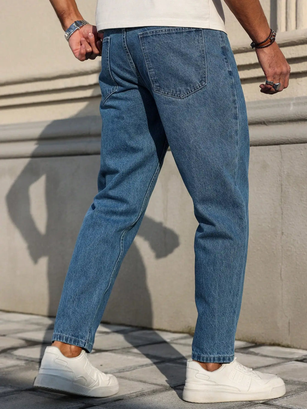 Men's Jeans Are Made of Classic Blue Denim Fabric with a Loose Fit,