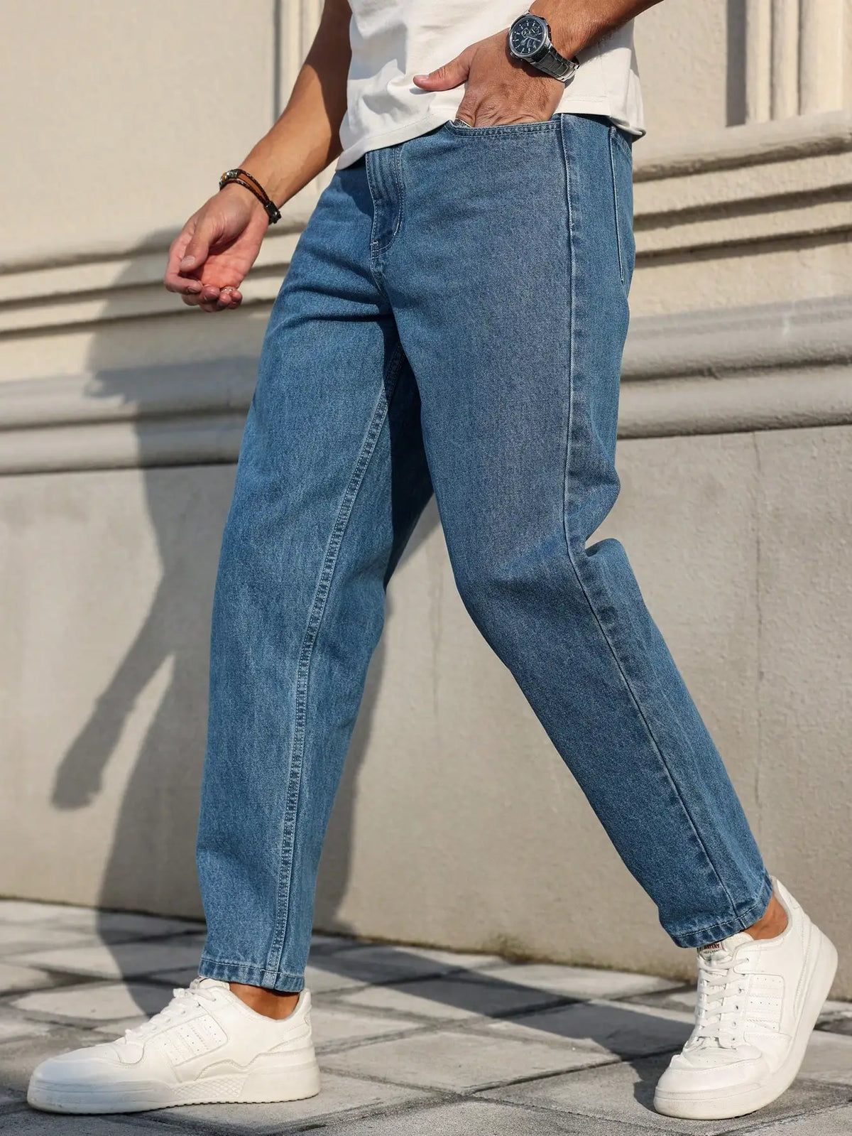 Men's Jeans Are Made of Classic Blue Denim Fabric with a Loose Fit,