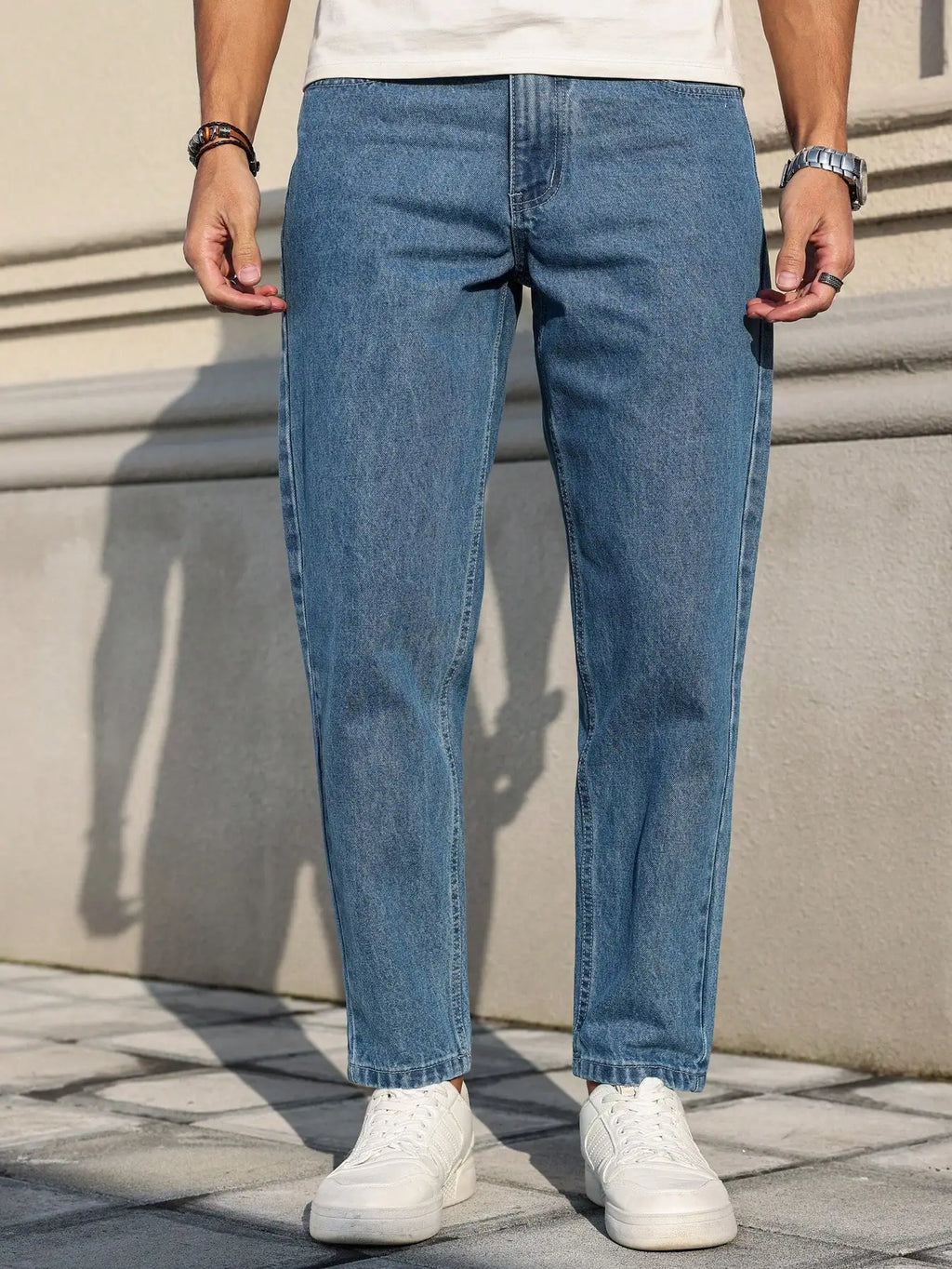 Men's Jeans Are Made of Classic Blue Denim Fabric with a Loose Fit,