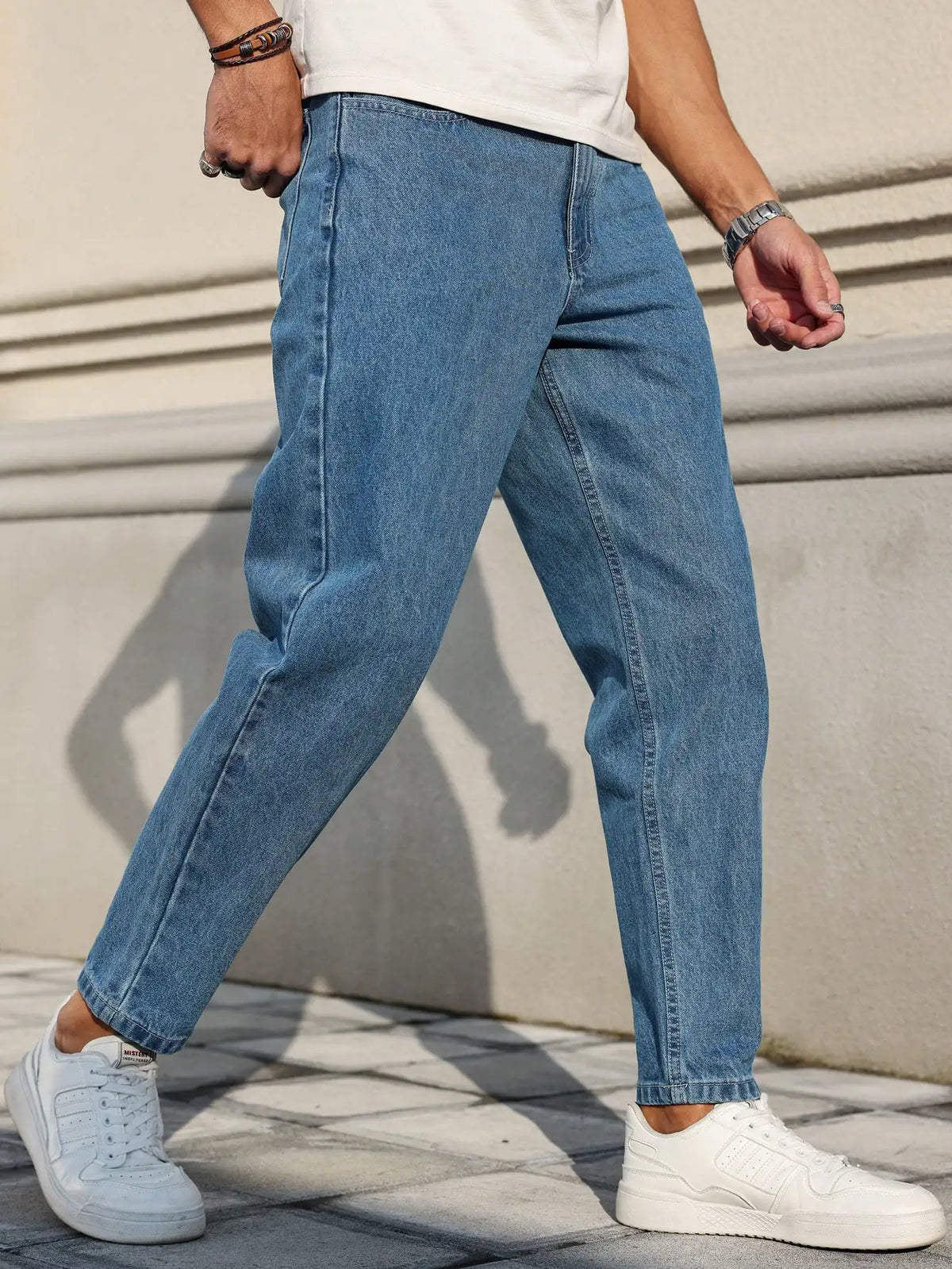Men's Jeans Are Made of Classic Blue Denim Fabric with a Loose Fit,